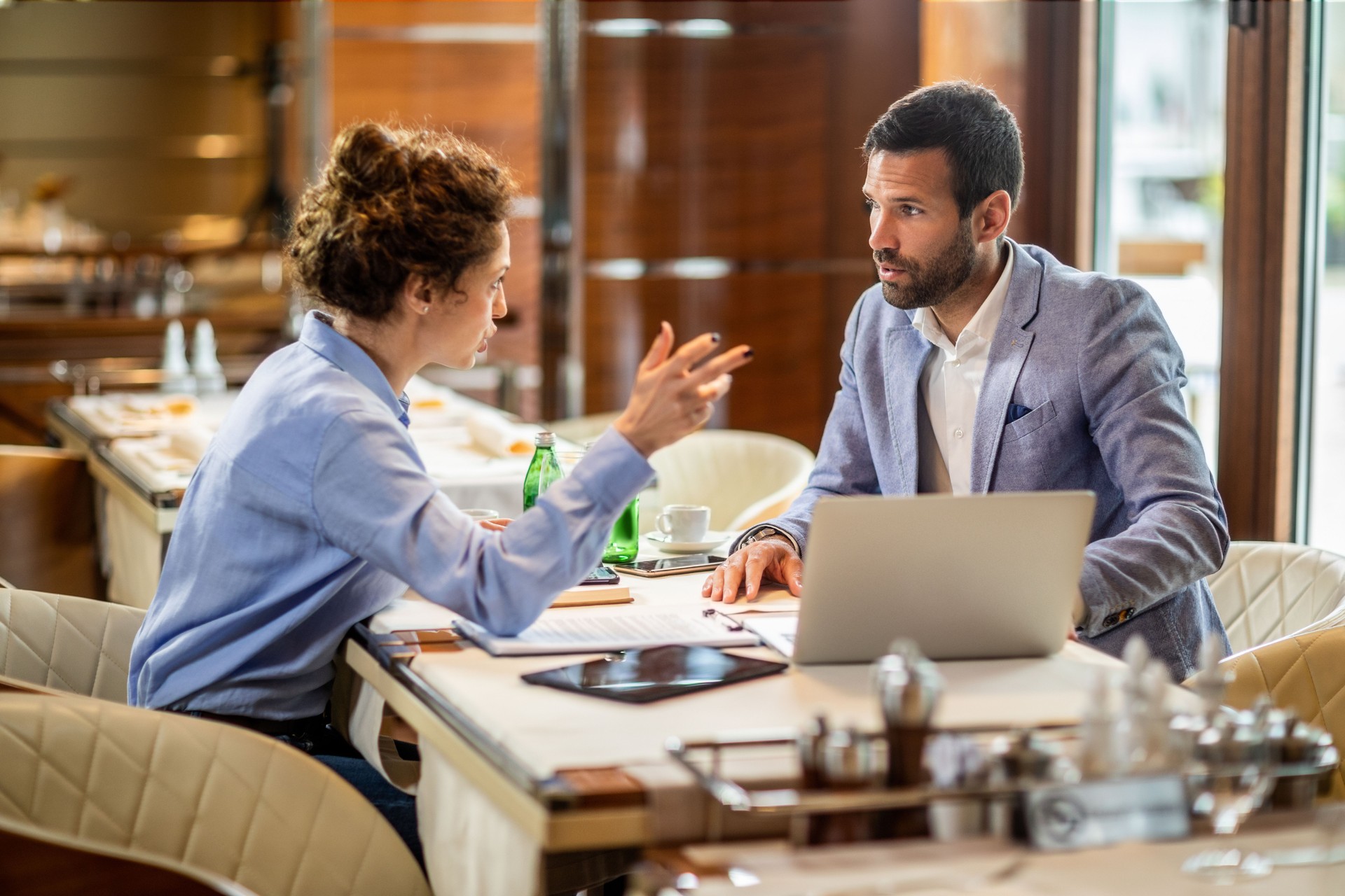 Business partners discussing decision strategies in an upscale restaurant