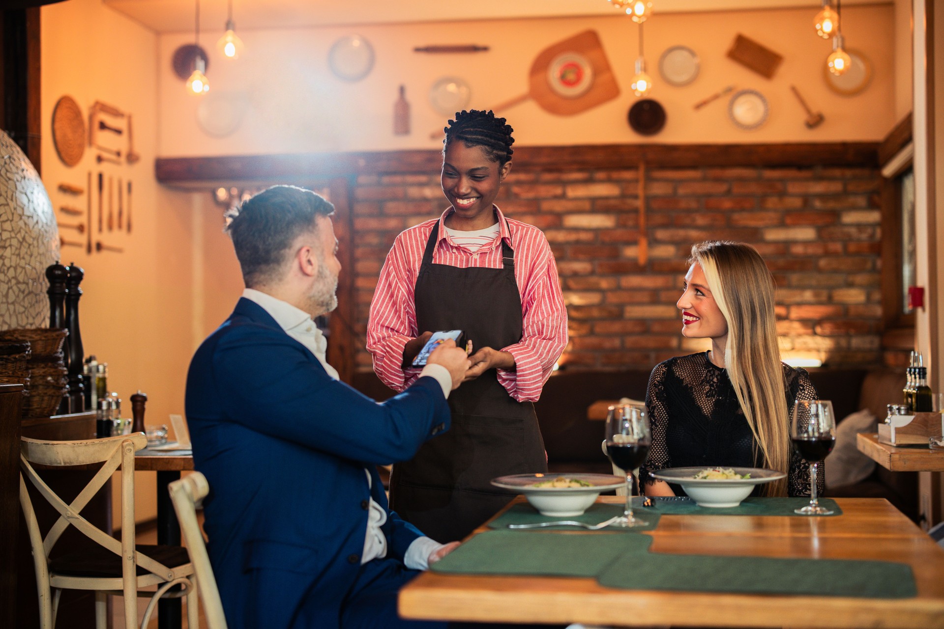 Waitress charging to a man for a dinner for two